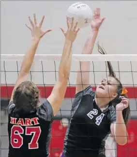  ?? Katharine Lotze/The Signal (See additional photos on signalscv.com) ?? Valencia’s Emily Thompson (24) goes for a kill over Hart’s Shelby Grubbs (67) Tuesday.