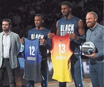  ?? PETRE THOMAS/USA TODAY SPORTS ?? Memphis Grizzlies general manager Zach Kleiman, left, and head coach Taylor Jenkins, right, present guard Ja Morant (12) and forward Jaren Jackson Jr. (13) with their All-star game jerseys prior to Wednesday’s game against the Utah Jazz at Fedexforum.