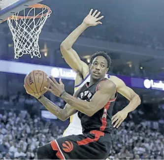  ?? JEFF CHIU/ASSOCIATED ?? Toronto Raptors guard DeMar DeRozan, foreground, passes the ball as he is guarded by Golden State Warriors centre JaVale McGee during Wednesday’s game in Oakland. DeRozan became the Raptors’ all-time leading scorer during the game.