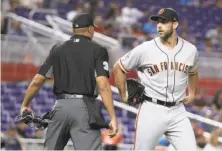  ?? Lynne Sladky / Associated Press ?? Madison Bumgarner had a contentiou­s night with ump Jeremie Rehak, who ejected him after he was lifted from the game.