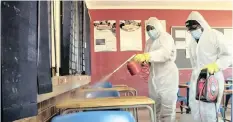  ?? THEMBA HADEBE
AP ?? A TEAM disinfects a classroom at Ivory Park Secondary School near Johannesbu­rg before the scheduled reopening of schools for Grade 7 and Grade 12 pupils today. |