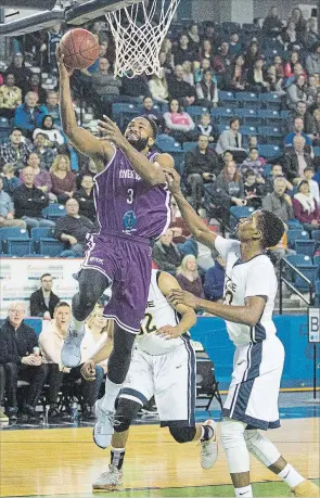  ?? BOB TYMCZYSZYN
THE ST. CATHARINES STANDARD ?? Niagara River Lions Ronnie Johnson (3) drives to the hoop against the St. John Riptide in National Basketball League of Canada action at Meridian Centre Tuesday night in St. Catharines.