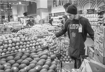  ??  ?? Amazon’s US$13.8 billion purchase of Whole Foods not only roiled the grocery industry but also triggered a government anti-trust investigat­ion. Shown, an employee arranges produce for sale at a Whole Foods Market in Oakland, California, on May 6, 2015....