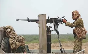  ?? AFP ?? A pro-government militiaman fires a machine gun near the city of Al Jah in Hodeida province, 50km from the port city of Hodeida.