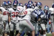  ?? JULIO CORTEZ — THE ASSOCIATED PRESS ?? New York Giants offensive tackle Bobby Hart, center, scuffles with defensive tackle Damon Harrison during a brawl between players after a play at NFL football training camp, Thursday in East Rutherford, N.J.