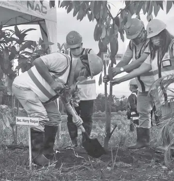  ??  ?? SEC ROQUE plants his tree in Rio Tuba with assistance from Nelson Acob, barangay captain; JB Baylon, Corp. Comms VP for NAC; and Engr. Cynthia E. Rosero, Resident Mine Manager for RTN.