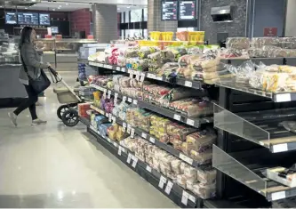  ?? DOUG IVES/THE CANADIAN PRESS ?? Various brands of bread sit on shelves in a grocery store in Toronto on Wednesday, Nov. 1. The Competitio­n Bureau’s investigat­ion into allegation­s of bread price fixing includes at least seven companies including Loblaw and Weston Bakeries, according...