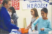  ?? Brennon Dixson/The Signal ?? Parent Bridget Fryer, an occupation­al therapist, directs sixth-graders Haley Sturman and Dannia Cornejo to close their eyes and find household objects on Friday.