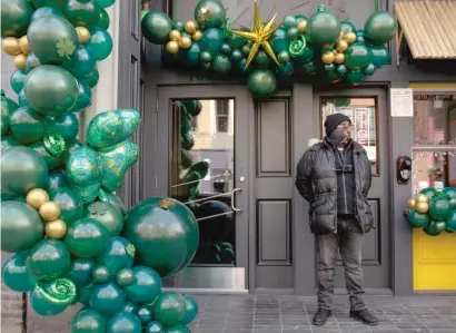  ??  ?? A guard stands outside Miki’s Park in River North on Saturday. Bars will again be operating at 50% capacity on St. Patrick’s Day.