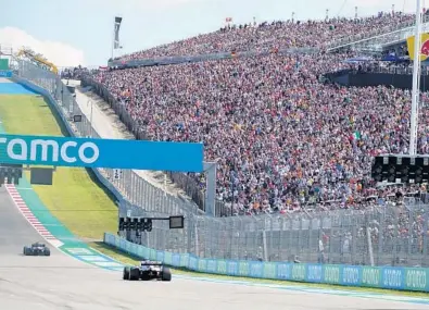  ?? DARRON CUMMINGS / AP ?? Fans watch as cars approach the first turn during a F1 U.S. Grand Prix auto race in Austin, Texas, in October. The Miami Grand Prix on Sunday is making an even bigger splash for F1 racing in America.