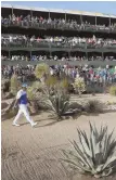  ?? AP PHOTO ?? HE’S SURROUNDED: Hideki Matsuyama walks up the 16th surrounded by some of yesterday’s record crowd at the Waste Management Phoenix Open.