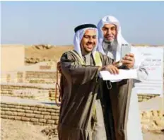  ?? AP ?? ■People take selfies next to what is believed to be the house of Abraham near the Great Ziggurat in the archaeolog­ical area of the Sumerian city-state of Ur, yesterday.