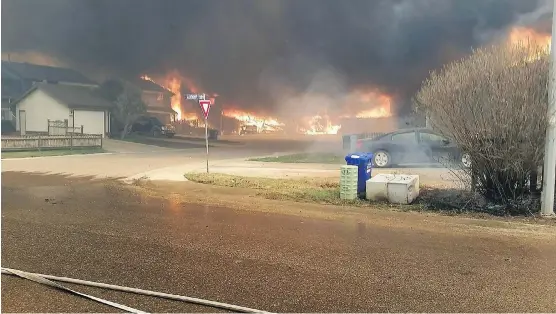  ?? MATT COLLINS ?? This was the kind of scene that confronted firefighte­rs in Abasand. Fort McMurray fire captain Matt Collins took this photograph on May 3, 2016.