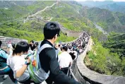  ??  ?? Visitors throng the Great Wall of China, one of the must-see sights. Below, the Taj Mahal, which can be a chaotic experience as a holidaymak­er