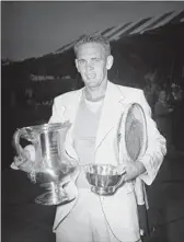  ?? John Lindsay Associated Press ?? JACK KRAMER stands with trophies he won by defeating Tom Brown at the U.S. Nationals in 1946.