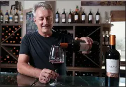  ?? BEA AHBECK/NEWS-SENTINEL ?? Bokisch Vineyards’ owner, CEO and vigneron, Markus Bokisch, pours its 2014 Tizona Gran Reserva at the Clements Hills vineyard on Friday.