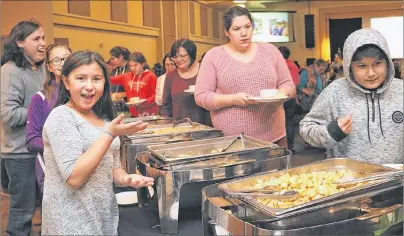  ?? SUBMITTED PHOTOS/ADAM GOULD ?? Future rising star Jenessa Paul shows off the Shrove Tuesday pancake mania menu of goodies at Membertou’s annual community awards banquet.