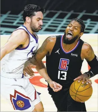  ?? Ashley Landis Associated Press ?? PAUL GEORGE MAKES it clear that he was fouled by Denver’s Facundo Campazzo during the second quarter at Staples Center. George made five of 15 shots and scored 17 points.