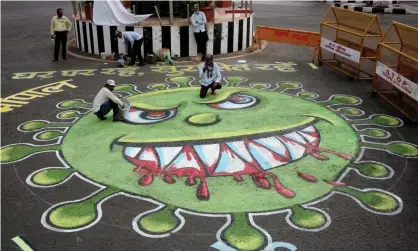  ?? Photograph: Sanjeev Gupta/EPA ?? Coronaviru­s artwork painted on a road in Bhopal, India, depicting its distinctiv­e ‘spikes’.