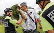  ?? BROOKE LAVALLEY/ THE COLUMBUS DISPATCH ?? Peter Bechtold of the Pittsburgh Bureau of Police pushes Jerry Stewart, dressed as a zombie, during an exercise in the crowd management course at the Delaware County Fair Grounds.