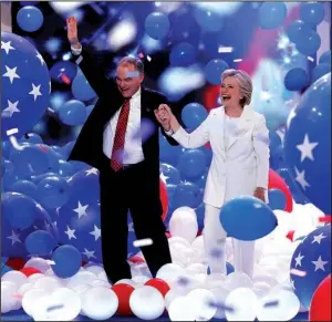  ?? AP/ J. SCOTT APPLEWHITE ?? Nominee Hillary Clinton and running mate Sen. Tim Kaine stroll through a shower of balloons Thursday as the Democratic National Convention wraps up in Philadelph­ia.