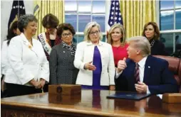  ?? AP PHOTO/PATRICK SEMANSKY ?? Rep. Liz Cheney, R-Wyo., center, speaks with President Donald Trump during a bill-signing ceremony for the Women’s Suffrage Centennial Commemorat­ive Coin Act in the Oval Office of the White House in Washington in 2019. Trump and his supporters are intensifyi­ng efforts to shame members of the party who are seen as disloyal to the former president.