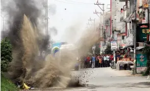  ?? — AP ?? Nepal Army’s bomb disposal team detonate explosives during the local elections in Bhaktapur, Nepal, on Sunday. Two explosive devices were planted across from a candidate’s house.