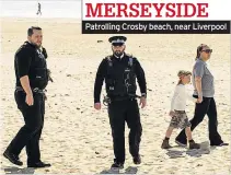  ??  ?? Patrolling Crosby beach, near Liverpool