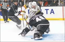  ?? Ringo H.W. Chiu Associated Press ?? THE GOLDEN KNIGHTS’ Evgenii Dadonov tries to get the puck past Kings goalie Cal Petersen in the first period. Petersen made 23 saves in the victory.