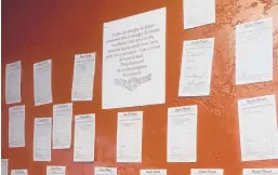  ?? THE DAWG HOUSE ?? Receipts for prepaid meals hang on a wall inside The Dawg House. Customers pay for them so people in need can get a meal judgment-free and with no questions asked.