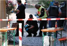  ?? (Michaela Rehle/Reuters) ?? POLICE SECURE the area of the attack yesterday in Ansbach, Germany.