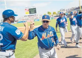  ??  ?? Mets manager Terry Collins, right, fist-bumps first base coach Tom Goodwin.