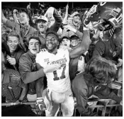  ?? GREGORY SHAMUS/GETTY ?? Oklahoma’s Jordan Smallwood celebrates with fans after the Sooners’ 31-16 win over Ohio State in Columbus, Ohio.