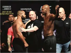  ??  ?? ANAHEIM: (L-R) Daniel Cormier poses with Jon Jones during the UFC 214 weigh-in at Honda Center on Friday in Anaheim, California. Cormier is fighting Jon Jones in the light heavyweigh­t title bout in Anaheim, California. — AFP