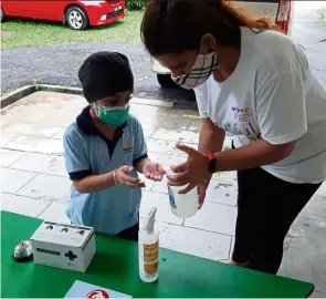  ?? — Jacquita GONZALES ?? as part of the government’s new ruling, children going to childcare centres must wear a face mask and clean their hands with hand sanitiser to stay safe from the Covid-19 virus.