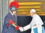  ?? AP ?? Pope Francis greets a Vatican Swiss guard as he arrives for the opening of a sex abuse prevention summit at Vatican City.