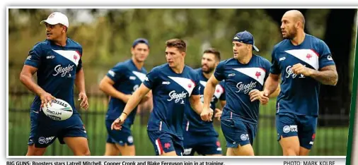  ?? PHOTO: MARK KOLBE ?? BIG GUNS: Roosters stars Latrell Mitchell, Cooper Cronk and Blake Ferguson join in at training.