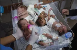  ?? FATIMA SHBAIR — THE ASSOCIATED PRESS FILE ?? Medics prepare premature babies for transport to Egypt after they were evacuated from Shifa Hospital in Gaza City to a hospital in Rafah, Gaza Strip, on Nov. 20.