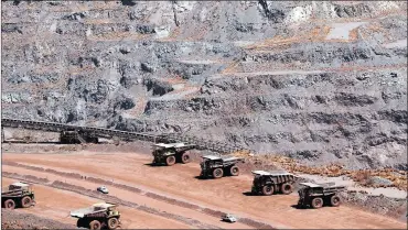  ?? PHOTO: REUTERS ?? Trucks are seen waiting to be loaded at Kumba Iron Ore’s Kathu mine. The group’s shares spiked yesterday after it forecast that earnings for last year were expected to have more than doubled.