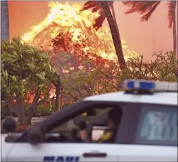  ?? The Maui News file / MATTHEW THAYER photo ?? Maui’s Finest, MPD, on the detail during the August 8 Lahaina wildfires scope the area to see where help is needed.