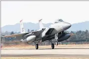  ?? SENIOR AIRMAN COLBY L. HARDIN / U.S. AIR FORCE VIA GETTY IMAGES ?? A U.S. Air Force F-15 fighter jet touching down at Gwangju Air Base in Gwangju, South Korea. South Korea and the United States began a large-scale military aircraft and military personnel annual joint exercise Monday.