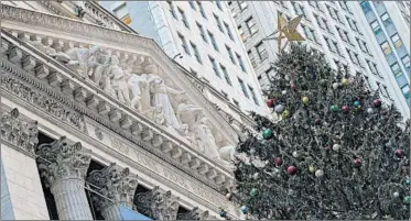  ?? MARY ALTAFFER/AP ?? New York Stock Exchange is festive amid a wary market.