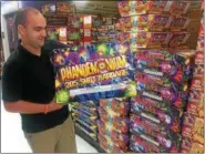  ?? PEG DEGRASSA — DIGITAL FIRST MEDIA ?? Phantom Fireworks manager Brian Bush shows off his full supply of aerial repeaters at the store. Customers can choose from dozens and dozens of choices of the repeaters. Phantom advertises some of them as “The Almighty 500 Gram Aerial Repeaters.” Bush said repeaters and mortars are the most frequent choices selected by store customers.