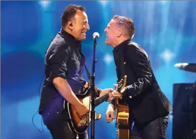  ?? CHRIS JACKSON, GETTY IMAGES ?? Bruce Springstee­n, left, and Bryan Adams perform together during Saturday’s closing ceremonies.