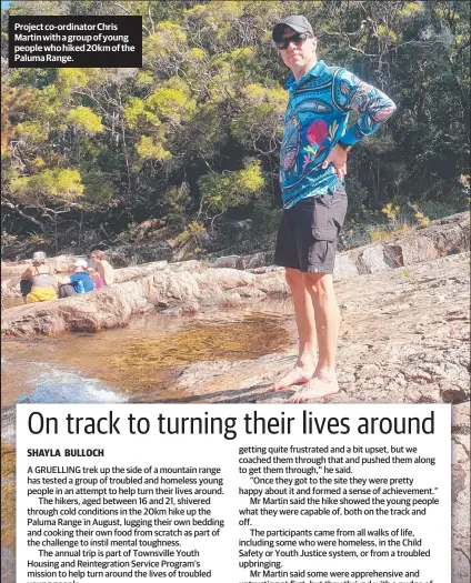  ??  ?? Project co-ordinator Chris Martin with a group of young people who hiked 20km of the Paluma Range.