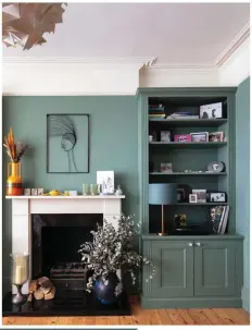  ?? ?? To create a feeling of space, Jenny chose to paint the built-in shelving and alcove cupboards the same colour as the walls – Green Smoke by Farrow & Ball