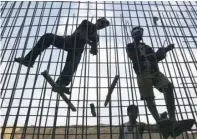  ?? — Reuters ?? Labourers fasten iron rods together at the constructi­on site of a commercial complex in the western Indian city of Ahmedabad.