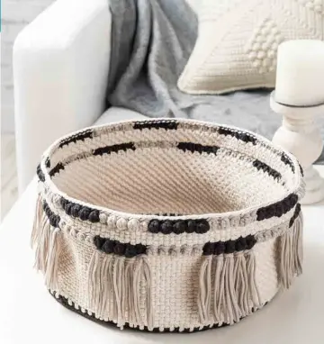  ??  ?? Cluster stitches mimic bobbles along the top edge of this contempora­ry basket. Crocheted using a bulky-weight cotton tape yarn, this sturdy basket is practical enough to hold magazines, your latest crochet project or natural decor items.