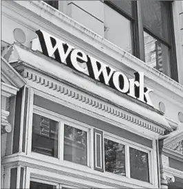  ?? TIMOTHY A. CLARY/GETTY-AFP ?? WeWork’s board agreed Tuesday to take a bailout from SoftBank Group Corp., which will secure an 80% stake.