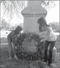  ?? Submitted photo ?? SOLDIERS REMEMBERED: Maddie and Bryna Mathis placed a large wreath at the Confederat­e Monument where 900 Confederat­e War dead are buried in a mass grave. The Little Rock National Cemetery Confederat­e Memorial is a stone memorial marker set in an...